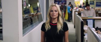 Movie still from “Bombshell” (2019), directed by Jay Roach – A woman with long blonde hair wearing a black top; Close Up shot, Over the shoulder angle