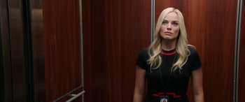 Movie still from “Bombshell” (2019), directed by Jay Roach – A woman standing in front of a wooden wall in an elevator; Close Up shot, Low angle