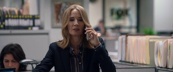 Movie still from “Bombshell” (2019), directed by Jay Roach – A woman talking on a cell phone while wearing a suit; Close Up shot, Low angle