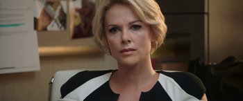 Movie still from “Bombshell” (2019), directed by Jay Roach – A person with short blonde hair; Close Up shot, Over the shoulder angle