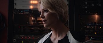 Movie still from “Bombshell” (2019), directed by Jay Roach – A woman with blonde hair wearing a black and white dress; Close Up shot, Over the shoulder angle