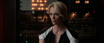Movie still from “Bombshell” (2019), directed by Jay Roach – A woman with blonde hair wearing a black and white dress; Close Up shot, Over the shoulder angle