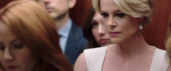 Movie still from “Bombshell” (2019), directed by Jay Roach – Two women and a man in a crowd of people; Close Up shot, Over the shoulder angle