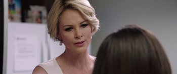 Movie still from “Bombshell” (2019), directed by Jay Roach – A person wearing a white dress; Close Up shot, Over the shoulder angle