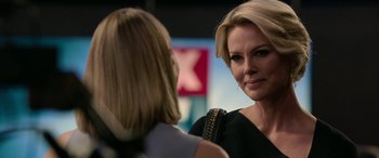 Movie still from “Bombshell” (2019), directed by Jay Roach – Two women talking to each other in front of a building; Close Up shot, Over the shoulder angle