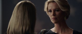 Movie still from “Bombshell” (2019), directed by Jay Roach – A woman looking at another woman in a black dress; Close Up shot, Over the shoulder angle