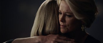 Movie still from “Bombshell” (2019), directed by Jay Roach – A woman hugging another woman in a dark room; Close Up shot, Over the shoulder angle