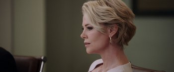 Movie still from “Bombshell” (2019), directed by Jay Roach – A person wearing a white shirt; Close Up shot, Low angle