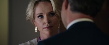 Movie still from “Bombshell” (2019), directed by Jay Roach – A person wearing a suit and tie; Close Up shot, Over the shoulder angle