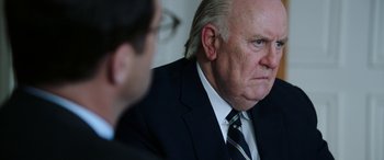 Movie still from “Bombshell” (2019), directed by Jay Roach – A man in a suit and tie looking at another man in a suit and tie; Close Up shot, Over the shoulder angle