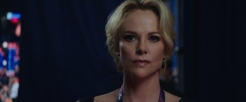 Movie still from “Bombshell” (2019), directed by Jay Roach – A person with blonde hair; Close Up shot, Over the shoulder angle