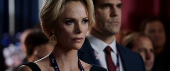 Movie still from “Bombshell” (2019), directed by Jay Roach – A woman and a man are standing next to each other; Close Up shot, Over the shoulder angle