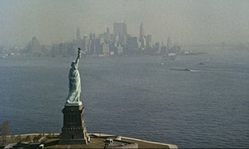 Movie still from “Bon Voyage!” (1962), directed by James Neilson – The statue of liberty is seen from a distance; Extreme Wide shot, High angle