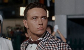 Movie still from “Bon Voyage!” (1962), directed by James Neilson – A man in a suit and bow tie looking to his left; Close Up shot, Low angle