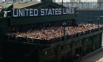 Movie still from “Bon Voyage!” (1962), directed by James Neilson – A crowd of people standing on top of a baseball field; Extreme Wide shot, High angle