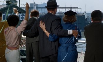 Movie still from “Bon Voyage!” (1962), directed by James Neilson – A group of people standing next to each other on a bridge; Wide shot, Over the shoulder angle