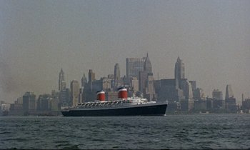 Movie still from “Bon Voyage!” (1962), directed by James Neilson – A large ship sailing in a large body of water; Extreme Wide shot, Low angle
