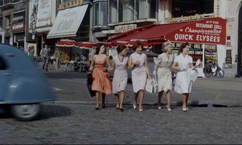 Movie still from “Bon Voyage!” (1962), directed by James Neilson – A group of women walking down a street; Wide shot, Low angle