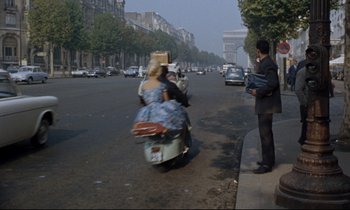 Movie still from “Bon Voyage!” (1962), directed by James Neilson – Two people on mopeds on the street in paris; Wide shot, High angle