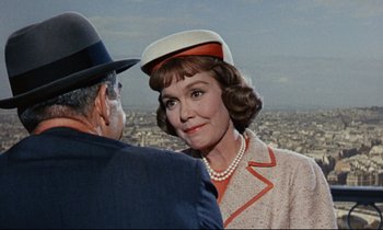 Movie still from “Bon Voyage!” (1962), directed by James Neilson – An older woman wearing a hat and a jacket; Close Up shot, Over the shoulder angle