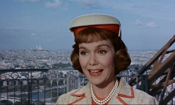 Movie still from “Bon Voyage!” (1962), directed by James Neilson – A person wearing a suit and hat; Close Up shot, Low angle