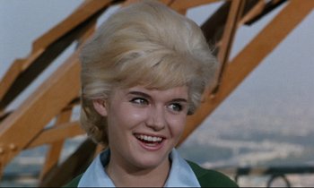 Movie still from “Bon Voyage!” (1962), directed by James Neilson – A person with a blonde wig; Close Up shot, Low angle