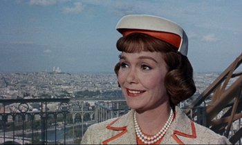 Movie still from “Bon Voyage!” (1962), directed by James Neilson – A person wearing a suit and hat; Close Up shot, Low angle