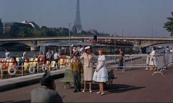 Movie still from “Bon Voyage!” (1962), directed by James Neilson – A group of people standing next to each other on a pier; Wide shot, High angle