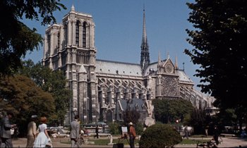 Movie still from “Bon Voyage!” (1962), directed by James Neilson – People walking in front of a large cathedral; Extreme Wide shot, High angle