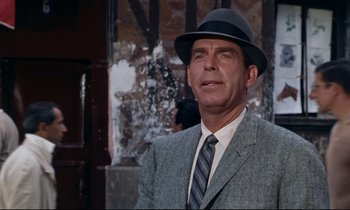 Movie still from “Bon Voyage!” (1962), directed by James Neilson – An older man in a suit and a hat; Close Up shot, Low angle