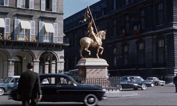 Movie still from “Bon Voyage!” (1962), directed by James Neilson – A statue of a man on a horse on a city street; Wide shot, Low angle