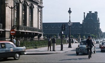 Movie still from “Bon Voyage!” (1962), directed by James Neilson – A man standing on the side of a road next to a street light; Extreme Wide shot, High angle