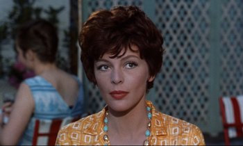 Movie still from “Bon Voyage!” (1962), directed by James Neilson – A person with short hair wearing a necklace; Close Up shot, Over the shoulder angle