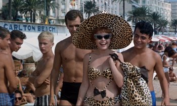 Movie still from “Bon Voyage!” (1962), directed by James Neilson – A group of young men and a woman in bathing suits; Medium shot, Low angle