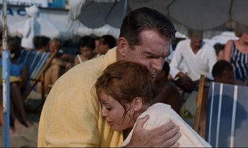 A man and a woman hugging in the rain