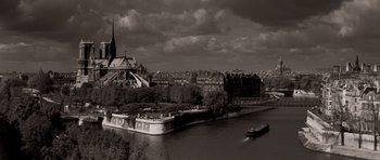Movie still from “Bonjour Tristesse” (1958), directed by Otto Preminger – A boat traveling down a river next to a large city; Extreme Wide shot, High angle