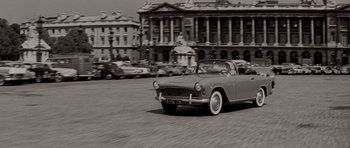Movie still from “Bonjour Tristesse” (1958), directed by Otto Preminger – An old fashioned car driving down a street; Wide shot, High angle