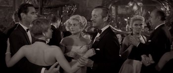 Movie still from “Bonjour Tristesse” (1958), directed by Otto Preminger – A man and a woman in formal wear at an event; Medium shot, Over the shoulder angle