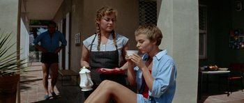 Movie still from “Bonjour Tristesse” (1958), directed by Otto Preminger – Two women sitting on the ground drinking coffee; Medium shot, Low angle