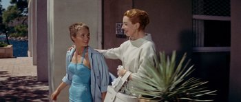 Movie still from “Bonjour Tristesse” (1958), directed by Otto Preminger – Two women are talking and laughing together outside; Medium shot, Over the shoulder angle