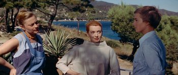 Movie still from “Bonjour Tristesse” (1958), directed by Otto Preminger – A woman standing in front of a body of water; Medium shot, Low angle