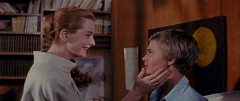 Movie still from “Bonjour Tristesse” (1958), directed by Otto Preminger – A woman and a boy are talking to each other in a room; Close Up shot, Over the shoulder angle