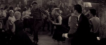 Movie still from “Bonjour Tristesse” (1958), directed by Otto Preminger – A group of people are dancing in a room; Medium shot, High angle