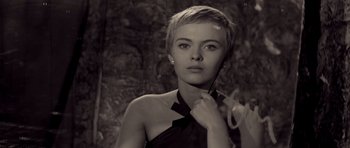 A black and white photo of a woman with short blonde hair