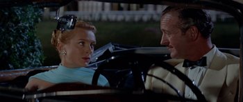 Movie still from “Bonjour Tristesse” (1958), directed by Otto Preminger – A man and a woman sitting in the back of a car; Close Up shot, Over the shoulder angle