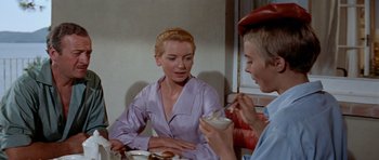 Movie still from “Bonjour Tristesse” (1958), directed by Otto Preminger – A woman sitting at a table with a man; Medium shot, Over the shoulder angle