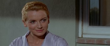 Movie still from “Bonjour Tristesse” (1958), directed by Otto Preminger – A person wearing a white shirt; Close Up shot, Over the shoulder angle