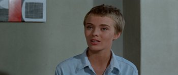 Movie still from “Bonjour Tristesse” (1958), directed by Otto Preminger – A woman with short blonde hair wearing a blue shirt; Close Up shot, Over the shoulder angle