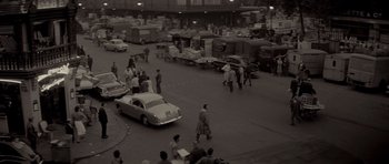 Movie still from “Bonjour Tristesse” (1958), directed by Otto Preminger – A black and white photo of a busy street; Extreme Wide shot, High angle