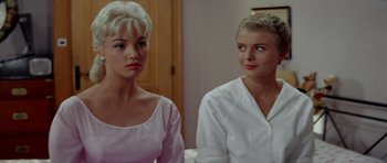 Movie still from “Bonjour Tristesse” (1958), directed by Otto Preminger – Two women in white shirts looking at each other; Close Up shot, Low angle